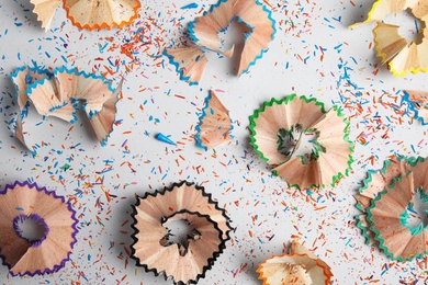 Pencil shavings on grey background, flat lay