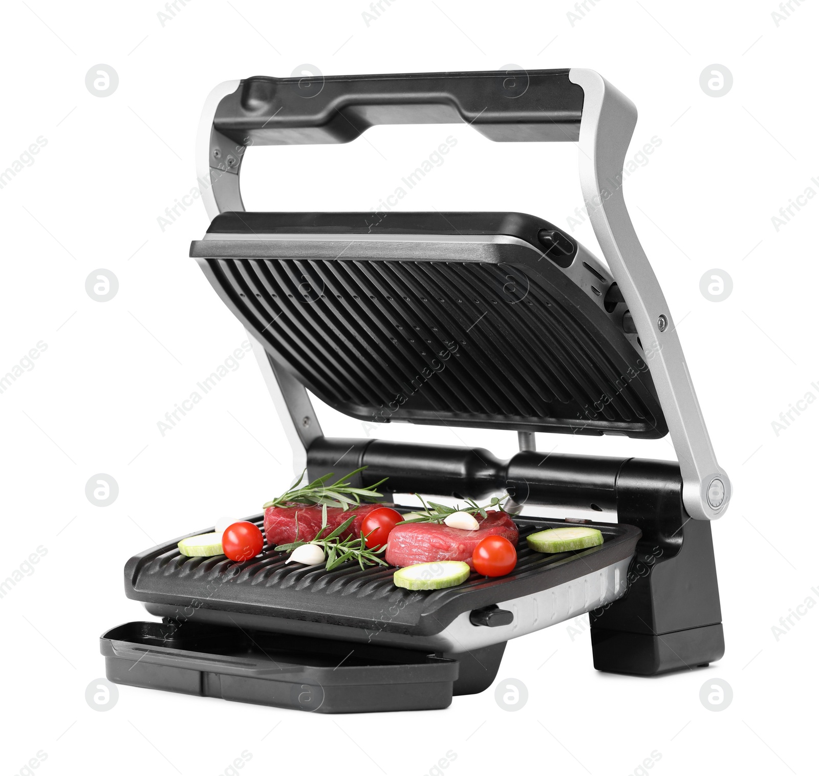 Photo of Electric grill with raw meat, rosemary and vegetables isolated on white