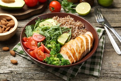 Healthy meal. Tasty products in bowl on wooden table