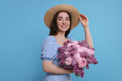 Photo of Beautiful woman with bouquet of spring flowers on light blue background