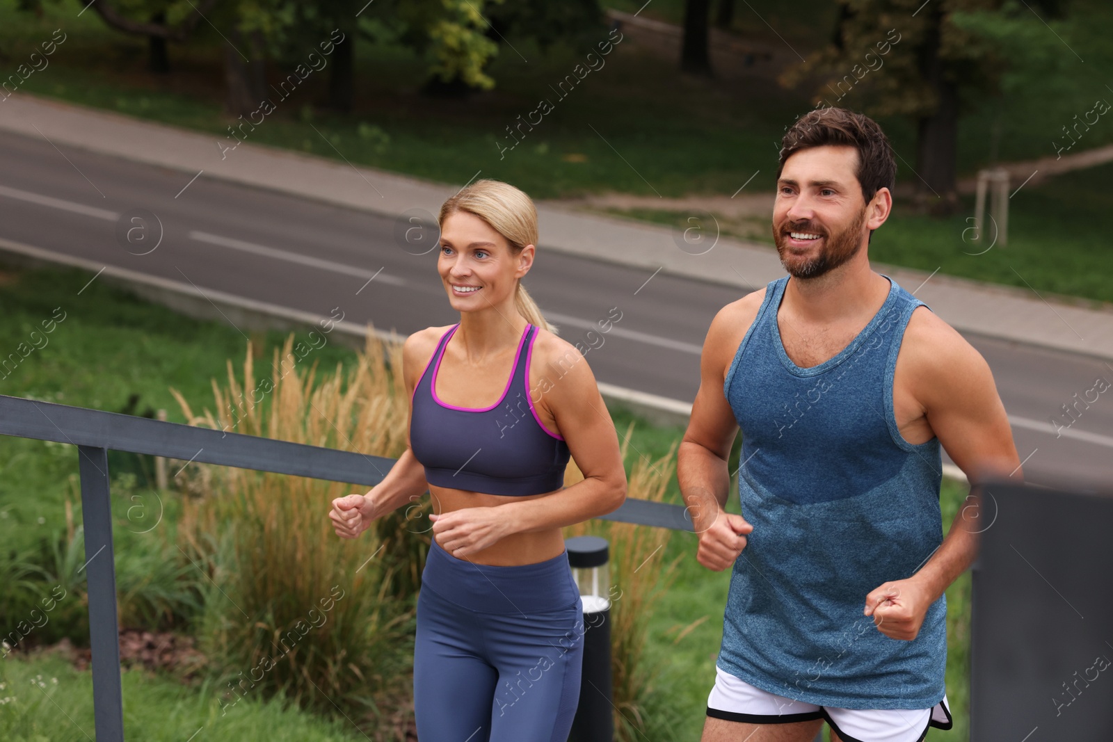 Photo of Healthy lifestyle. Happy couple running in park