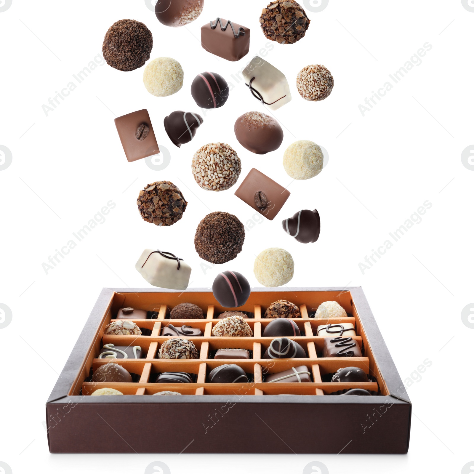 Image of Chocolate candies falling into box on white background