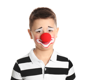 Preteen boy with clown makeup and nose on white background. April fool's day