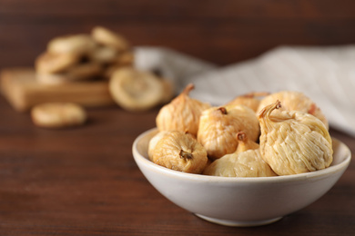 Tasty dried figs on wooden table, closeup. Space for text