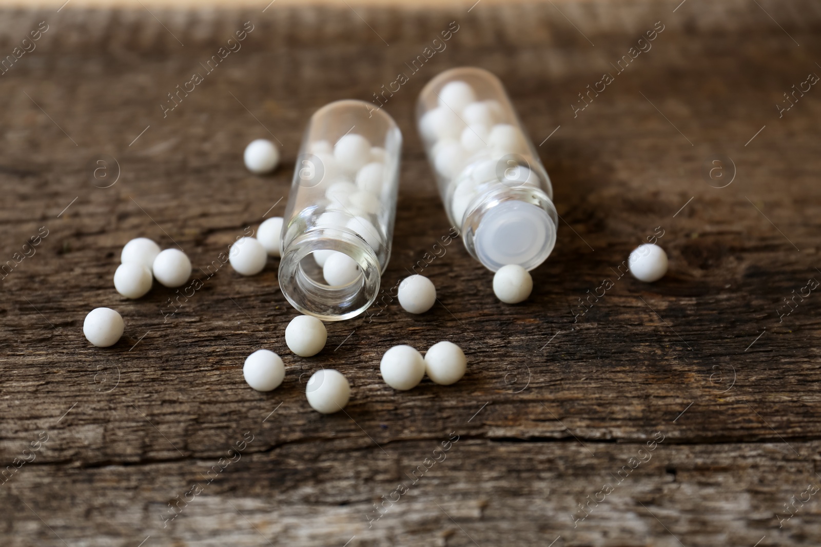 Photo of Bottles of homeopathic remedy on wooden table