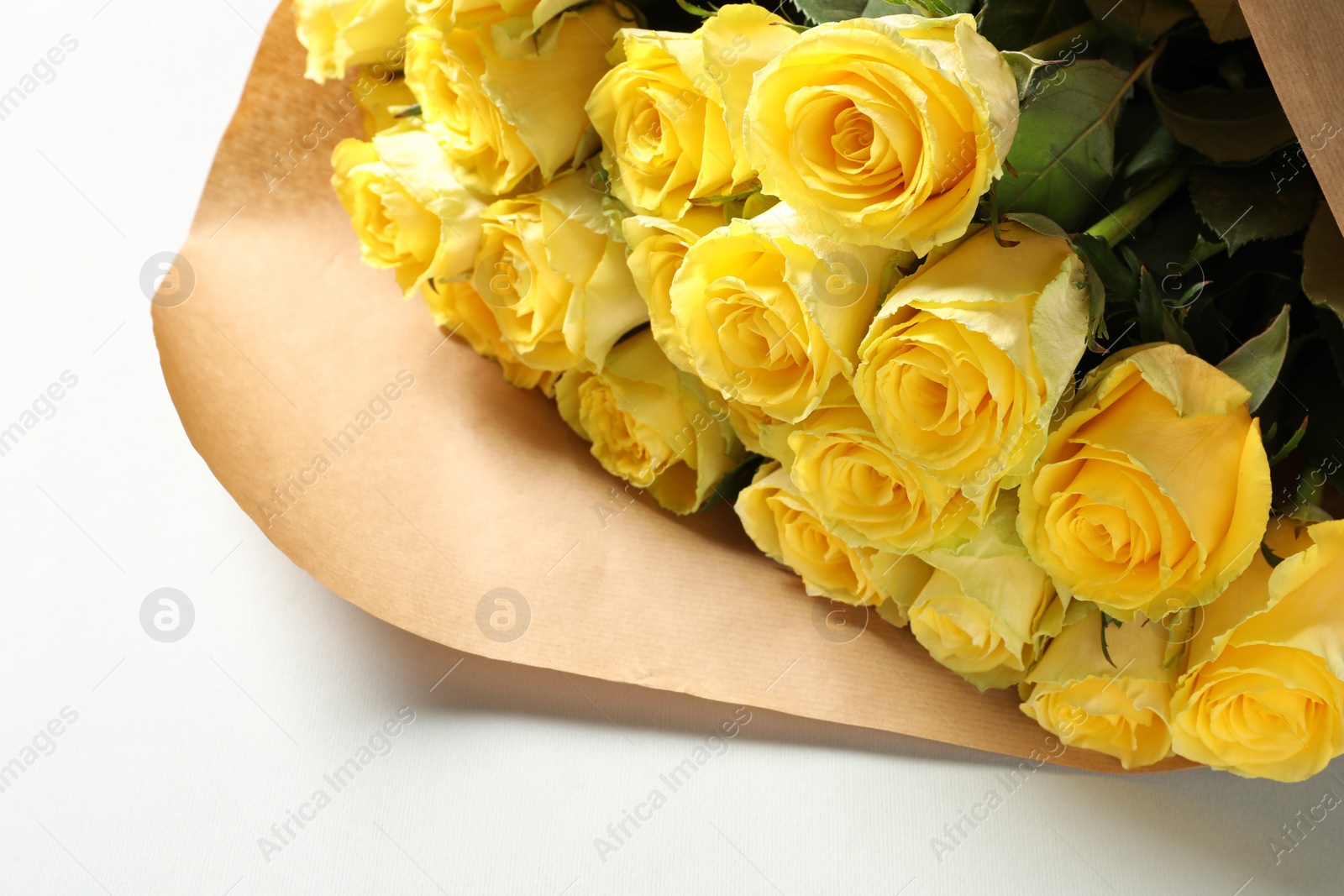 Photo of Beautiful bouquet of yellow roses on white background, closeup