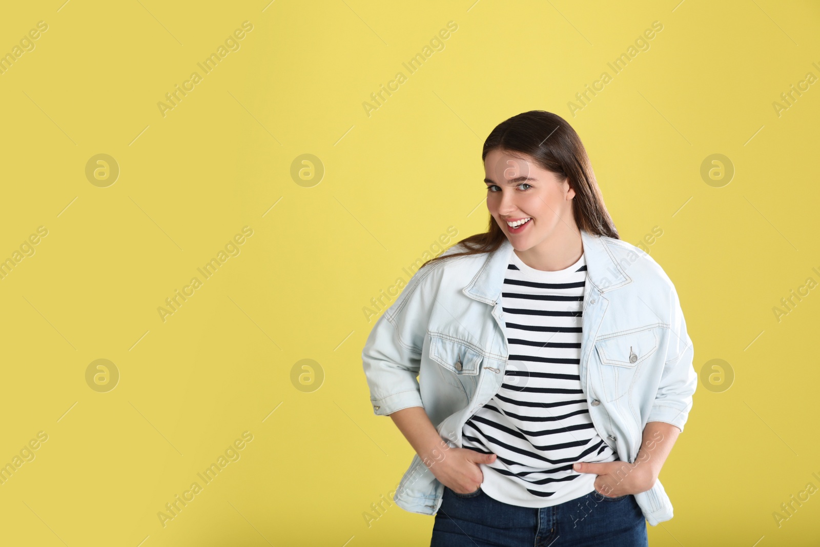 Photo of Portrait of young woman on yellow background. Space for text