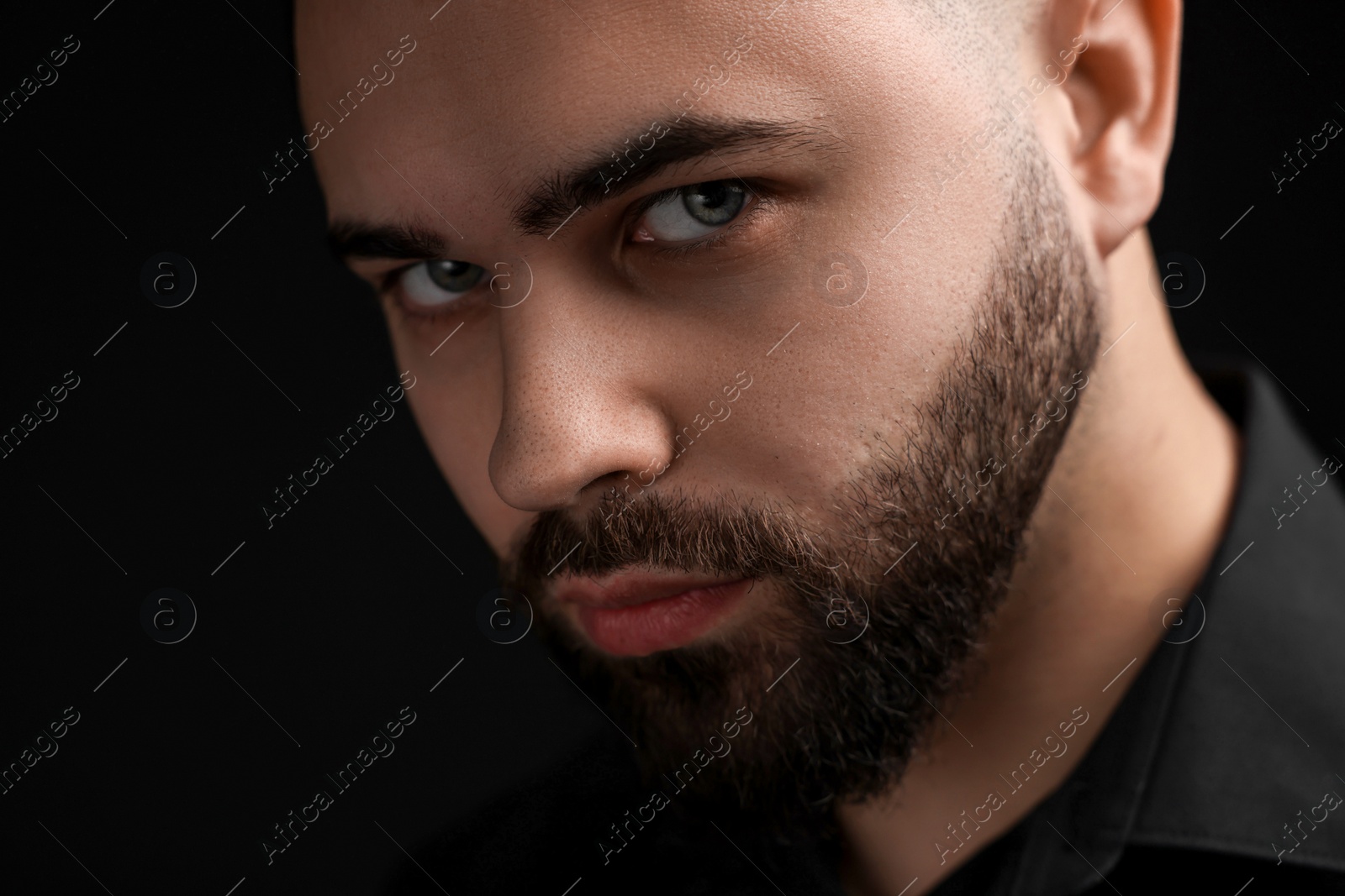 Photo of Evil eye. Man with scary eyes on black background