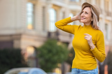 Portrait of happy mature woman on city street