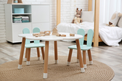 Little table and chairs with bunny ears in baby room. Interior design