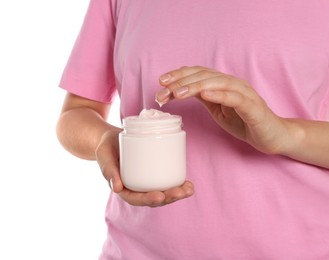 Photo of Woman taking hand cream from jar against white background, closeup