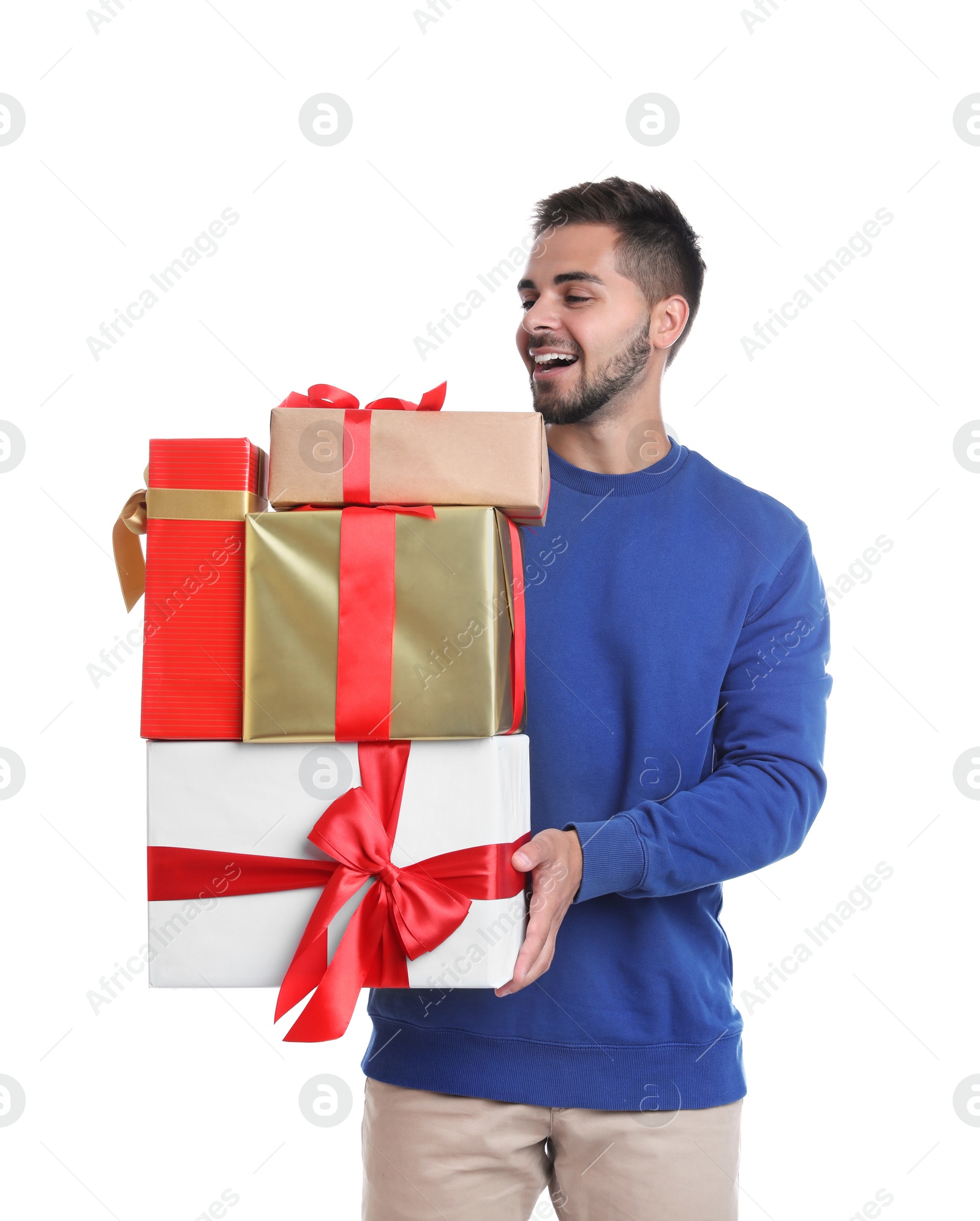 Photo of Happy young man holding Christmas gifts on white background