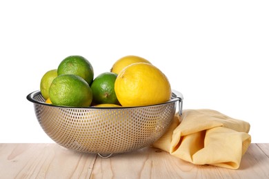 Photo of Fresh fruits in colander and napkin on wooden table against white background