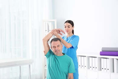 Doctor working with patient in hospital. Rehabilitation physiotherapy