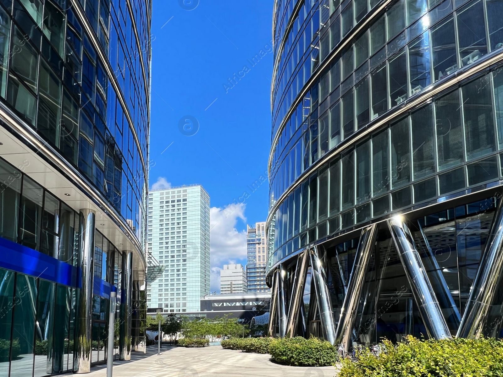 Photo of View of city street with modern buildings on sunny day