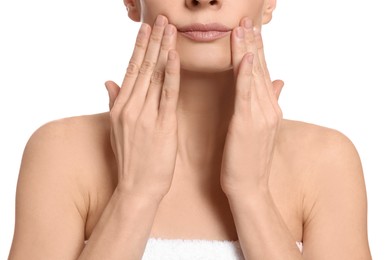 Woman massaging her face on white background, closeup