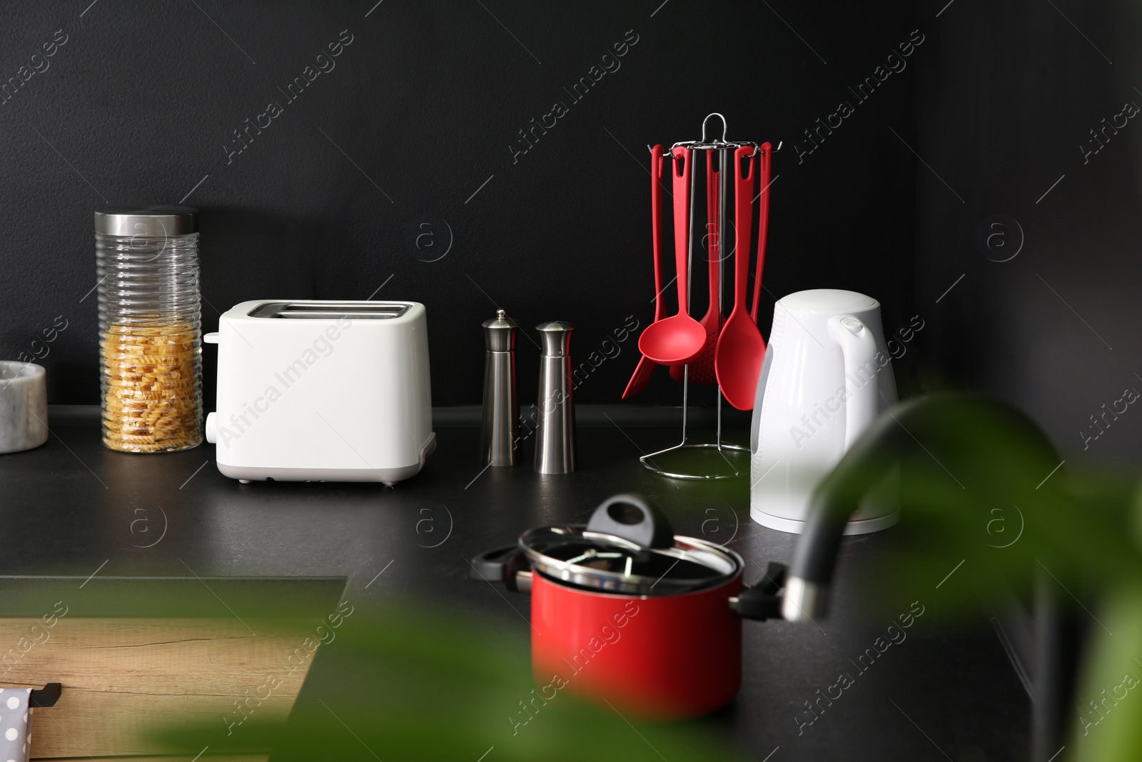 Photo of Stylish kitchen counter with houseware and appliances