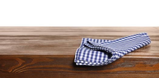 Photo of Checkered tablecloth on wooden table against white background
