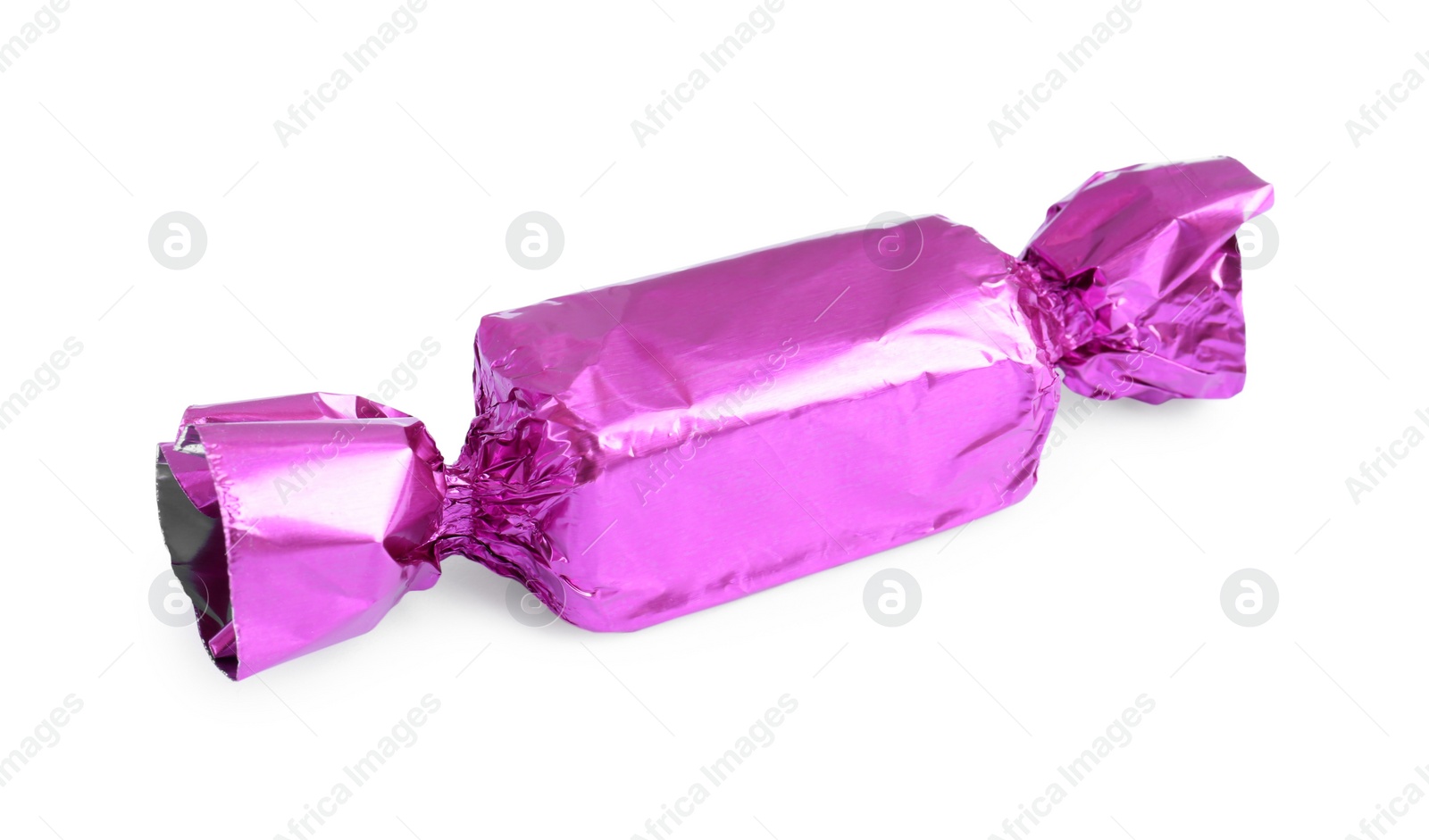 Photo of Tasty candy in violet wrapper isolated on white