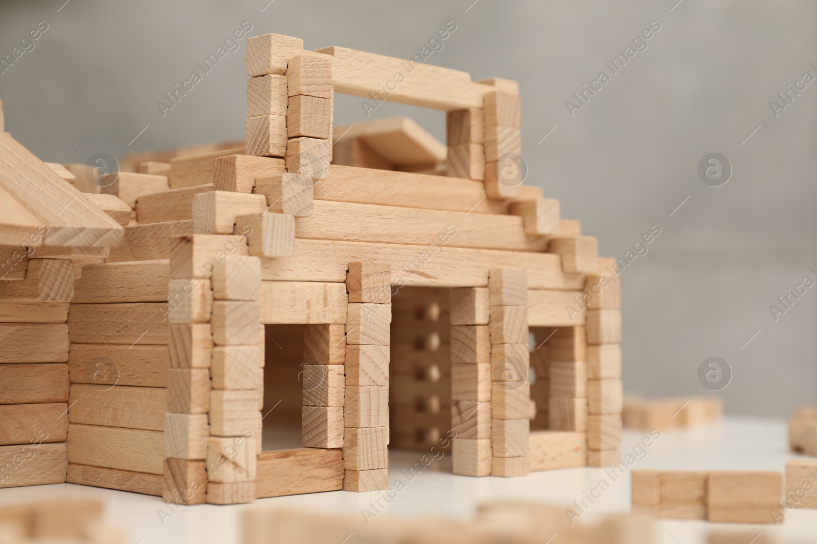 Photo of Wooden construction set on white table, closeup. Children's toy