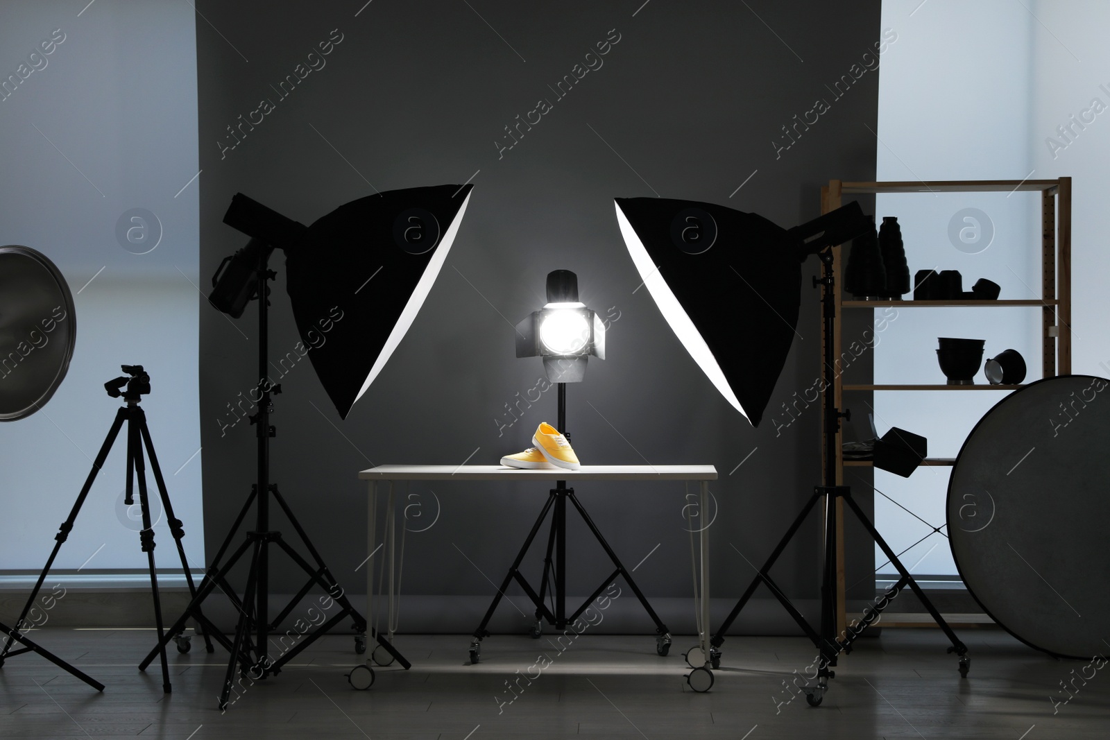 Photo of Professional photography equipment prepared for shooting stylish shoes in studio