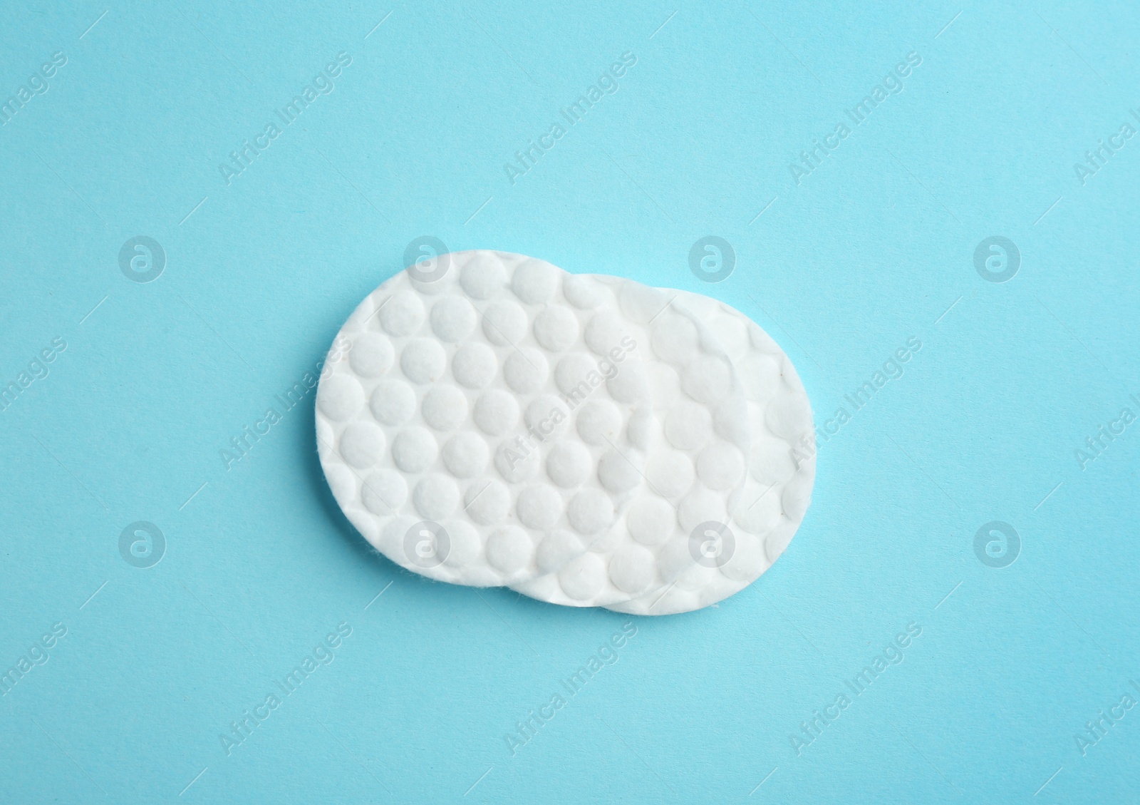 Photo of Cotton pads on color background, top view