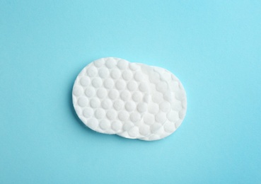 Photo of Cotton pads on color background, top view
