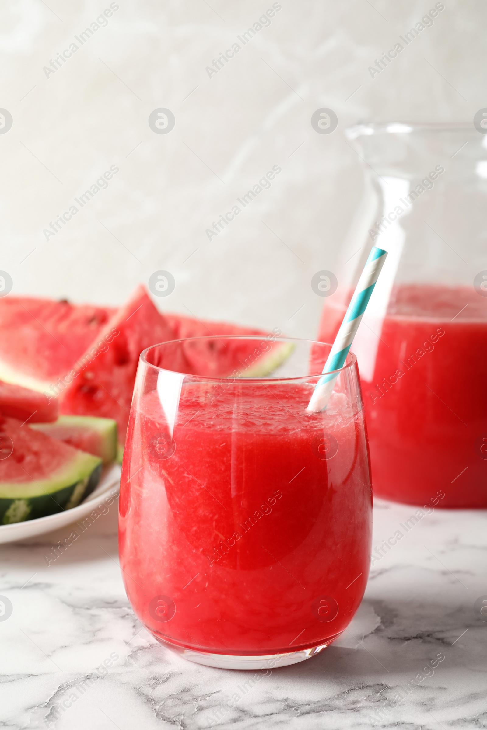 Photo of Tasty summer watermelon drink in glass served on table