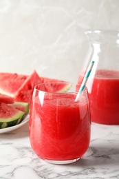 Photo of Tasty summer watermelon drink in glass served on table