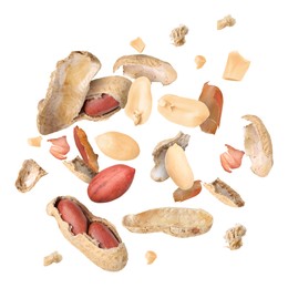 Peanuts and crushed pods in air on white background