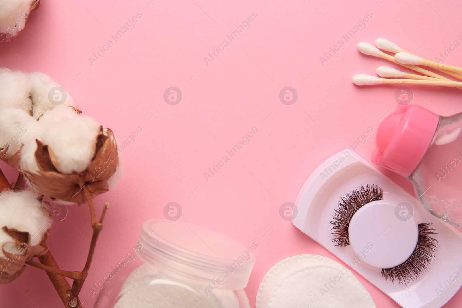 Photo of Flat lay composition with bottle of makeup remover on pink background. Space for text