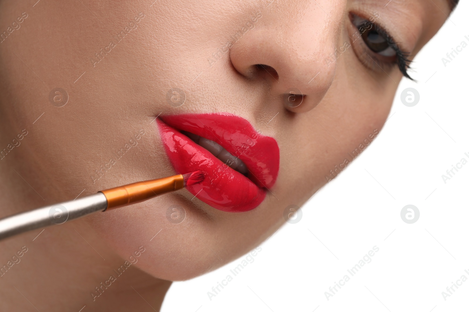 Photo of Woman applying lip gloss on white background, closeup