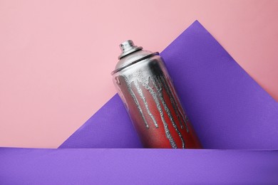 Photo of Used can of spray paint on color background, top view. Graffiti supply