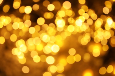 Photo of Gold glitter with bokeh effect on dark background