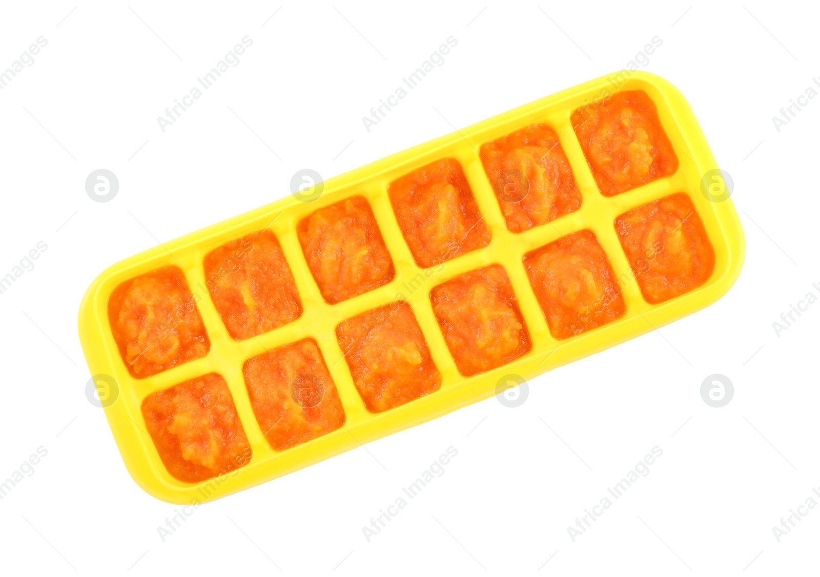 Photo of Puree in ice cube tray on white background, top view. Ready for freezing