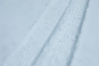 Photo of Car tire tracks on fresh snow, outdoors