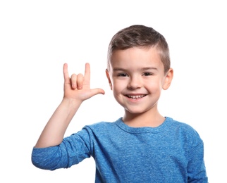 Photo of Little boy showing I LOVE YOU gesture in sign language on white background