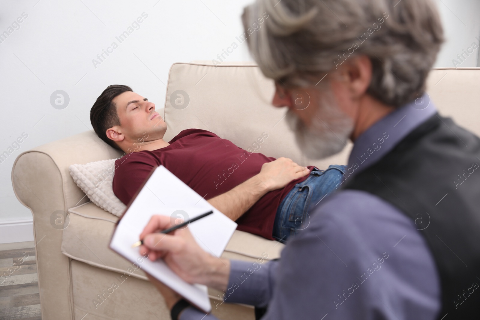 Photo of Psychotherapist and patient in office. Hypnotherapy session