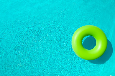 Inflatable ring floating in swimming pool, top view with space for text. Summer vacation