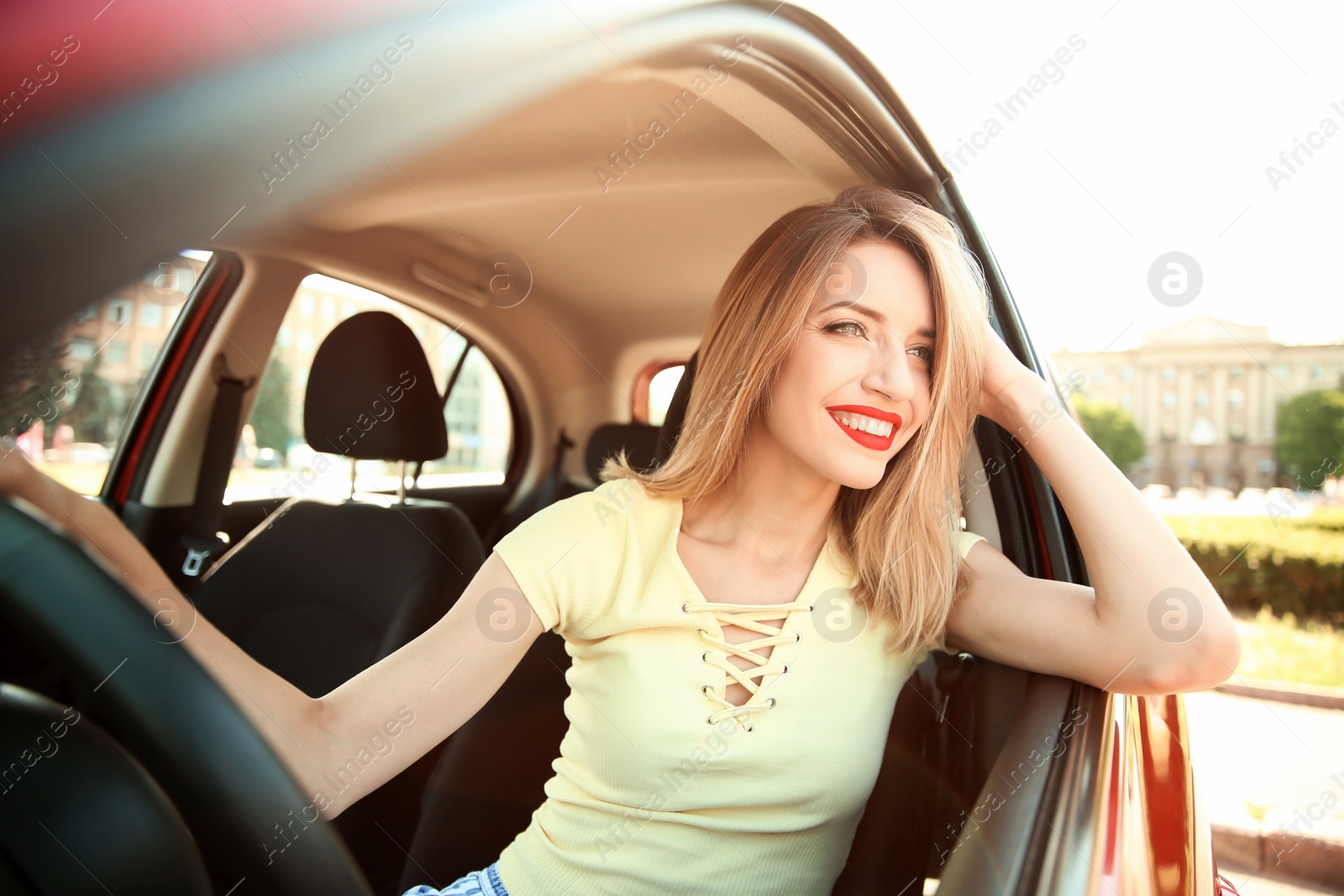 Photo of Young woman on driver's seat of car