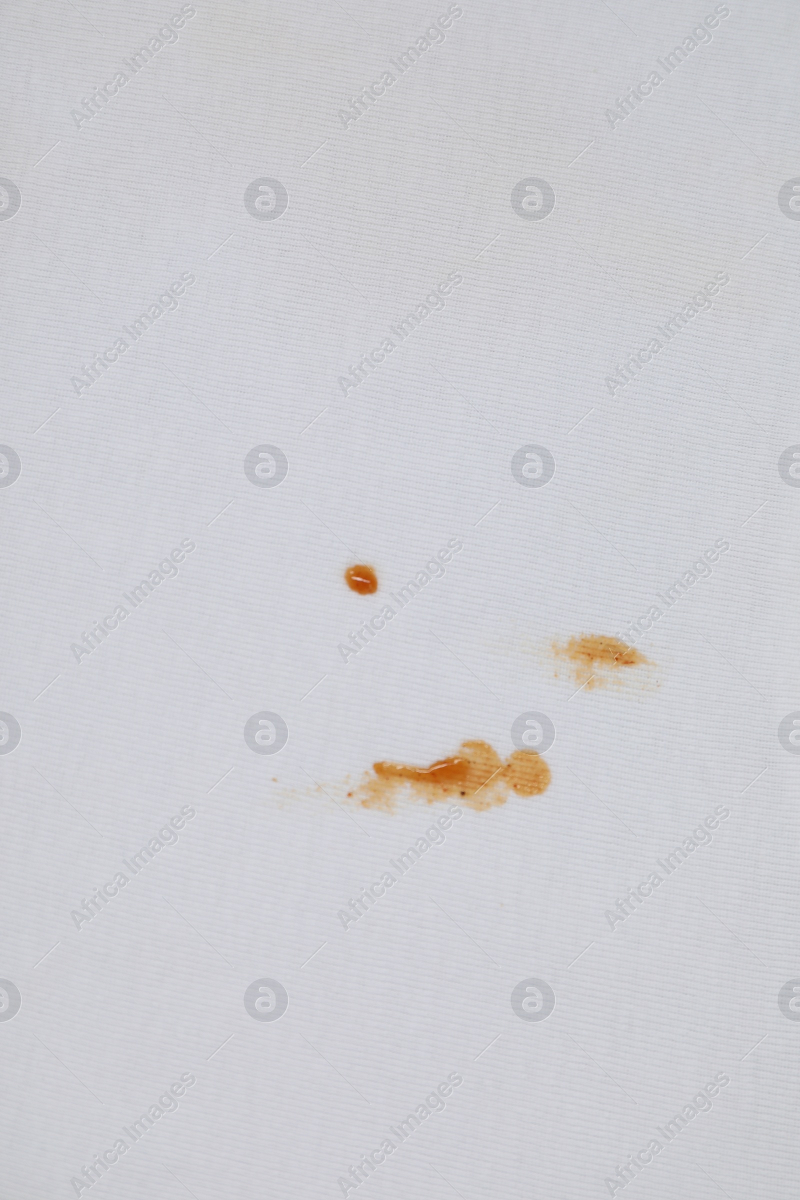 Photo of Stains of sauce on white fabric, top view