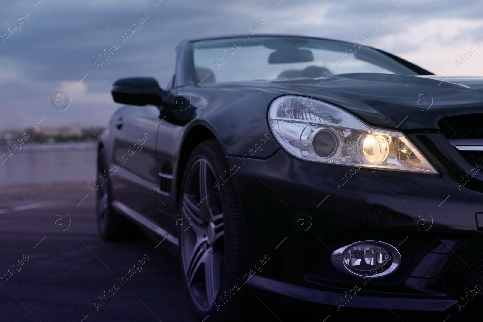 Photo of Luxury black convertible car outdoors in evening, closeup