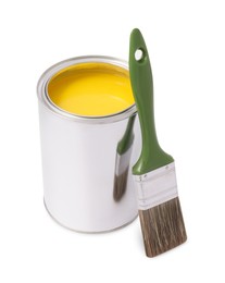 Photo of Can with yellow paint and brush on white background