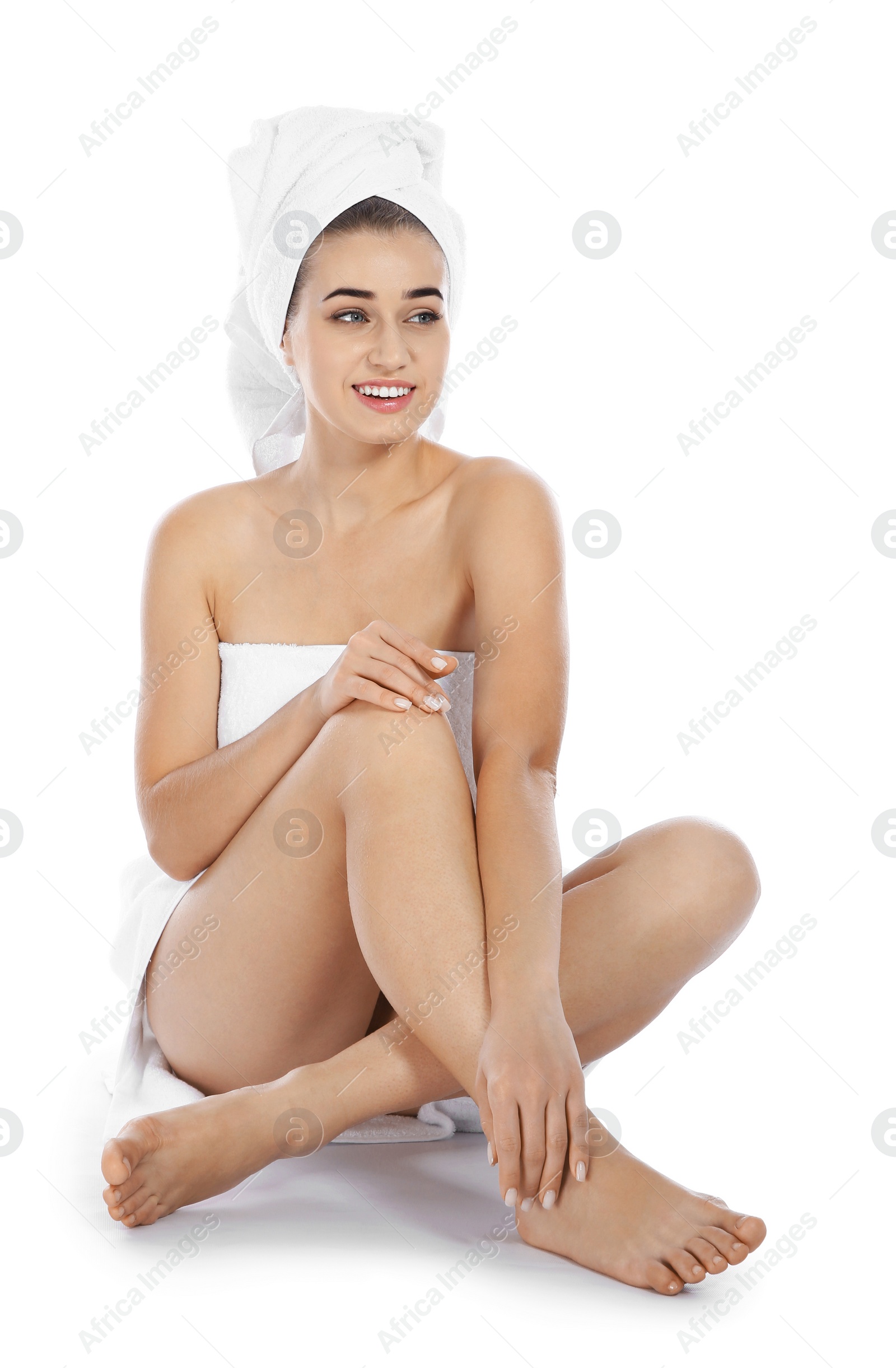 Photo of Portrait of young pretty woman with towels sitting on white background