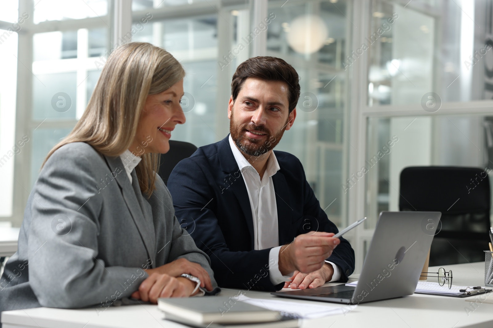 Photo of Lawyers working together at table in office