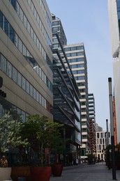 Exterior of beautiful modern skyscraper against blue sky