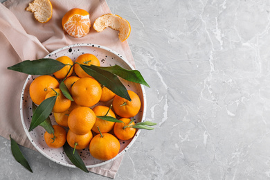 Photo of Fresh ripe tangerines on marble table, flat lay. Space for text
