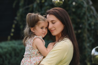 Photo of Portrait of mother with her cute daughter in park