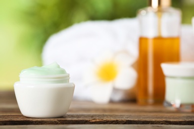 Jar of body care product on table against blurred background. Space for text