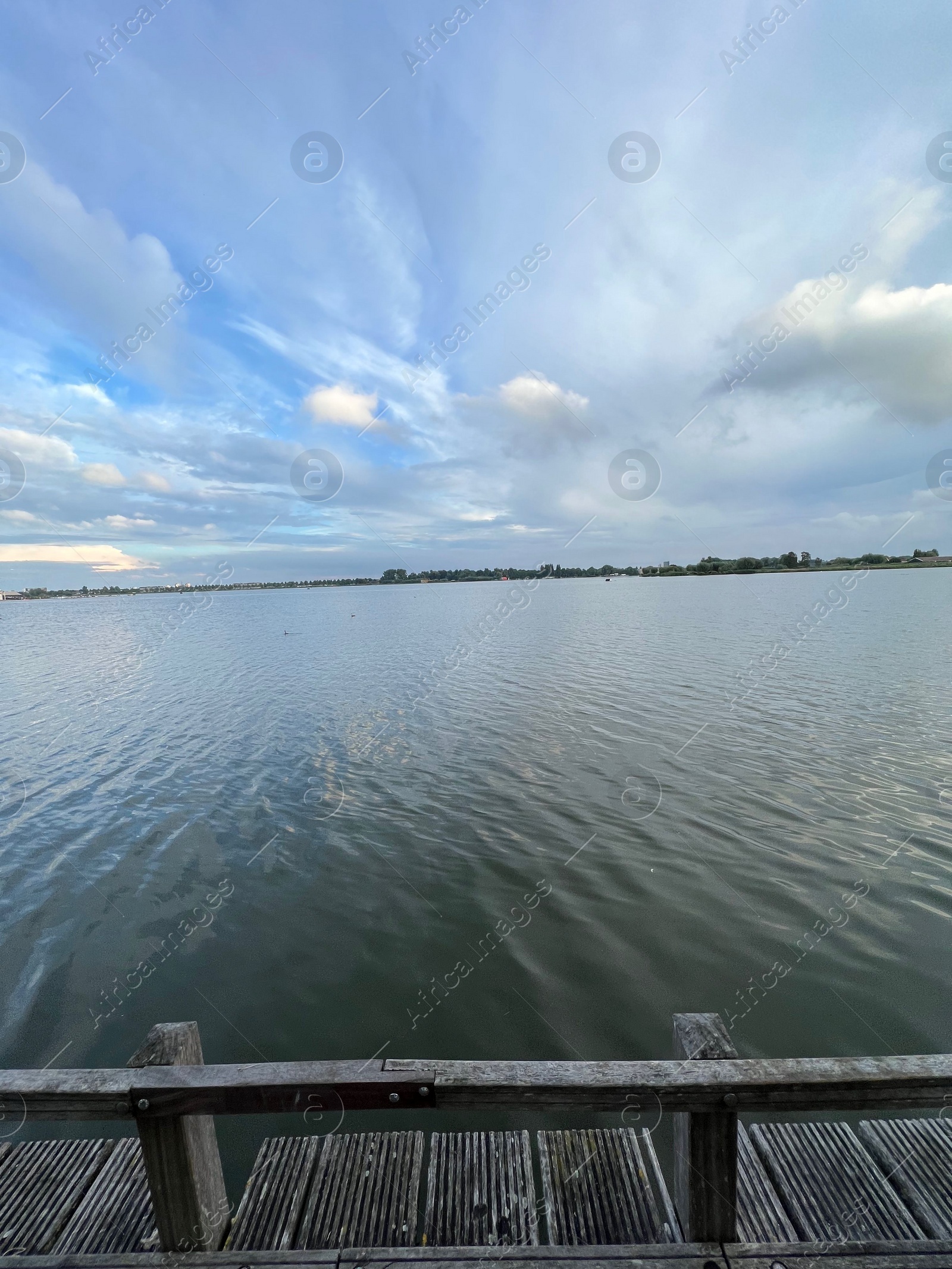 Photo of Picturesque view of river wooden pier and cloudy sky